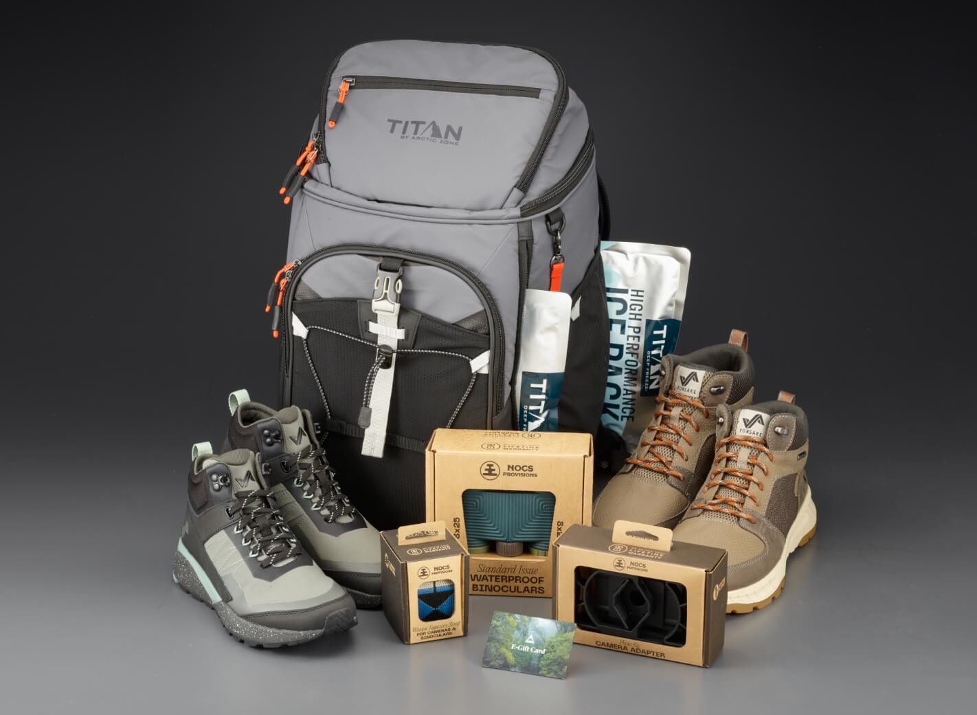 Enter for your chance to win an Outdoor Essentials Bundle featuring products from Forsake, Arctic Zone, Nocs, and Passenger Clothing. The featured image displays all products featured in the giveaway including an Arctic Zone backpack, Nocs binoculars and accessories, and a Passenger Clothing gift card.