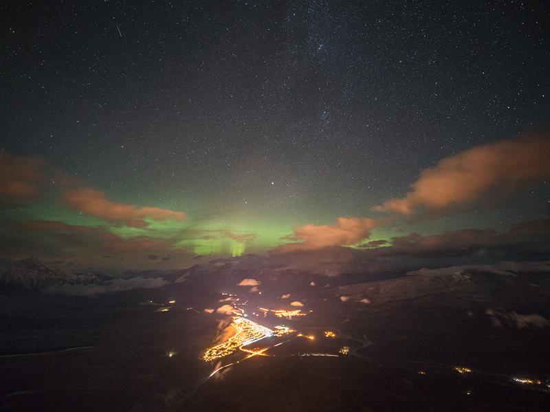 The image features an aerial view of the Milky Way as seen from Jasper, Canada.